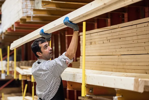 Timber ready to be used is stacked in the warehouse/timber yard waiting for the builder. ©iStock