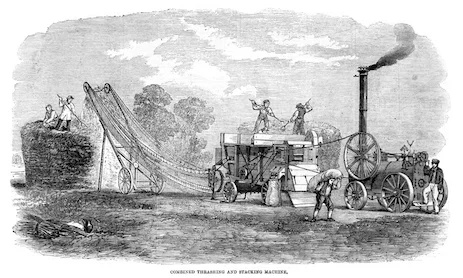 This is a machine that was used to separate grain from the plants and then stack the hay/straw into a haystack. The machine was powered by a steam engine. You can see a man carrying a sack of grain away ©iStock