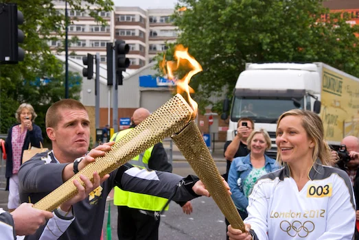 Hundreds of runners carry the torch to the Olympic venue. Each lights the torch of the next runner. ©iStock