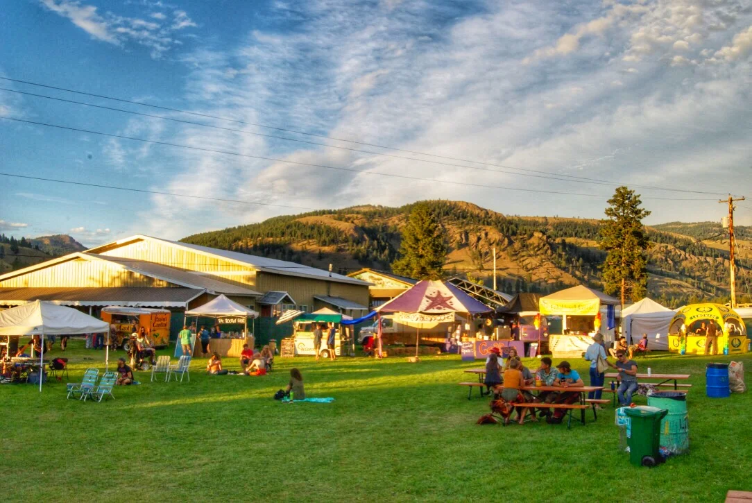 Oh how lovely it is, that moment you have picked up your wrist band from the ticket counter, and you leisurely walk into the fairground to go find your hosts for the weekend, veteran Ponderosa attendees, the food stands, the art exhibition, and the vendors. The grass is always so nice and fresh, the people so slow and smiley, and the colors just BAAAM- in your face. EATS There is always a fresh fruit stand at Ponderosa. Ross picks up the fruits from his orchard located in Oliver, which is right around the West side of Lake Osoyoos- fresh AND local. He even brings a selection of pickled vegetables, jams, and homemade soaps. This festival actually left me feeling more healthy than my normal week. New food trucks and food vendors appear as the needs of the festival changes and grows, but this year we enjoyed pancakes in the morning, craft coffee, coconut deserts, and thai food. Along with the fresh environmental theme of the festival, the coffee cart featured reusable mugs that you could borrow for the whole weekend for a small deposit. Why put your coffee in a paper cup, right Nick? VENDORS: This festival brings artists of all genres together. Painters, vintage clothing collectors, t-shirt printers, banjo and jewelry makers, whatever it is that you do, there is a place for you in this festival. Painters display their art, and can also setup their aisle by the stages and paint as they enjoy the afternoon sun, live music, and friendly smiles. I have found a cozy wool sweater, a vintage blue purse, and a ponderosa essential oil from the festival. My friend found 2 amazing pieces of jewelry and actually gave me one of her rock earrings (we each wear one, cause of love). YOGA: Every morning, there is free yoga on the grass. You can either bring your mat, or you can enjoy the soft grass. Might be a bit slippery and misty, but you might feel very grounded- literally. WASTE: All around the camp ground and fair ground, you could find waste, recycle, AND compost bins. Now that's freshness. 