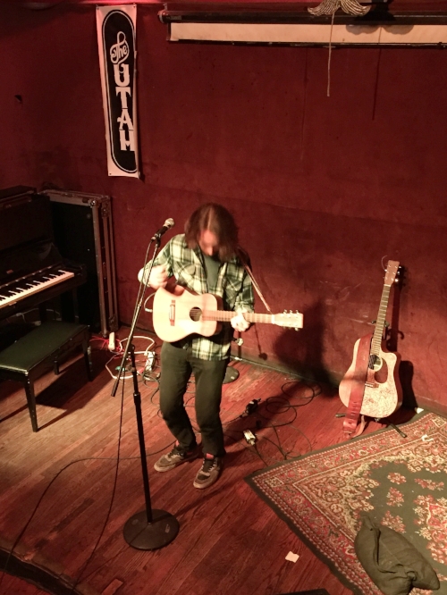 hey there's Devin Lane! But to his right is the house piano, and behind him is the house guitar. All those signatures? I believe it's from all the people who have hosted, co-hosted, or guest-hosted the HUOM. That fine strap on that guitar actually says The Utah. 