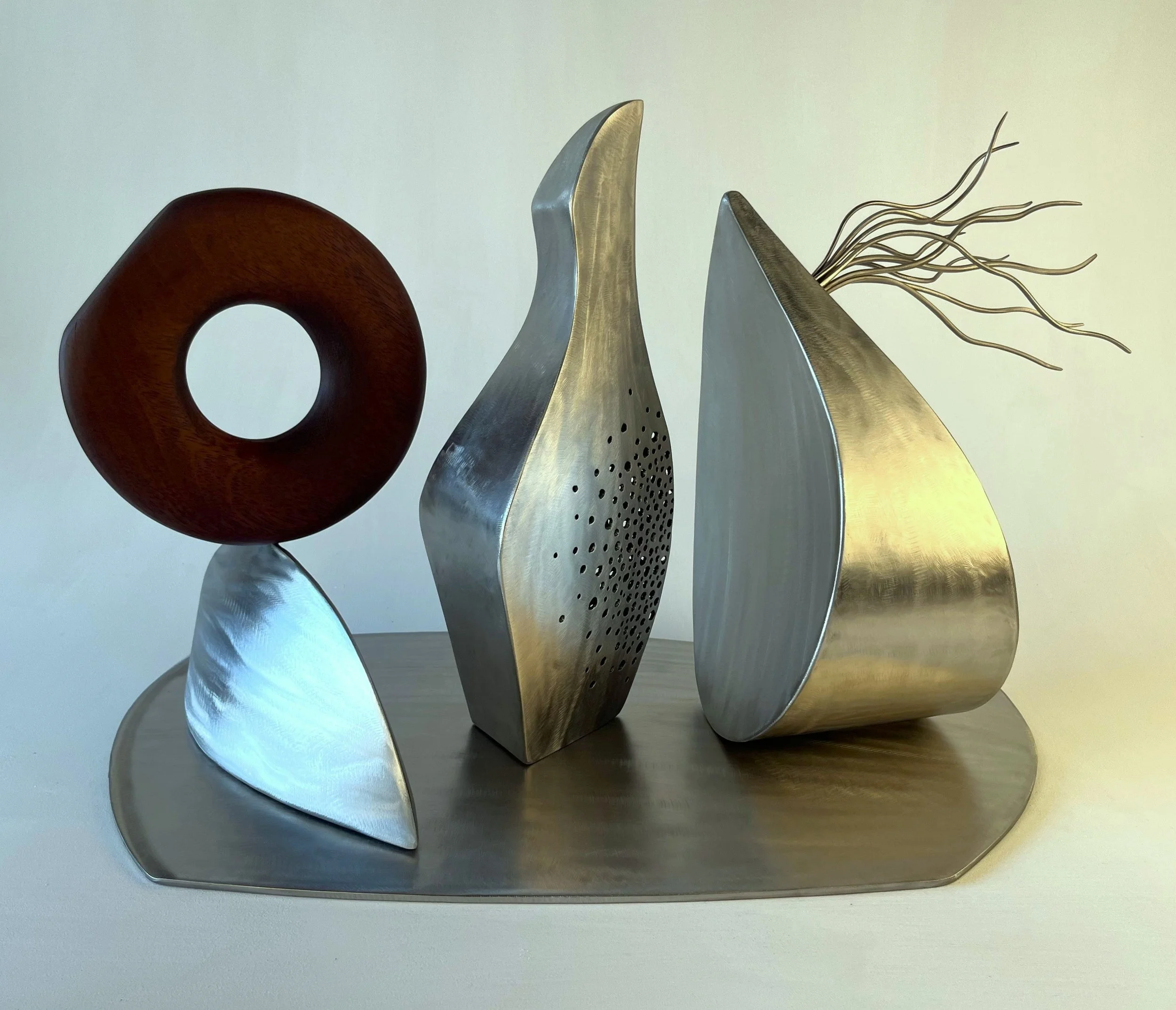 Saol Fos (2026) - stainless steel, wood - 40 x 68 x 34 cm