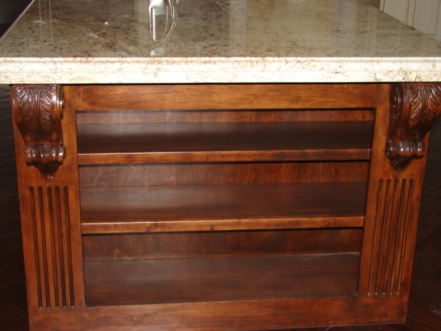  Maple island with book shelf, fluted columns and carved corbels. 