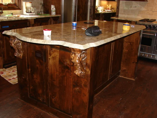  Knotty alder island with carved corbels and a raised panel back. 