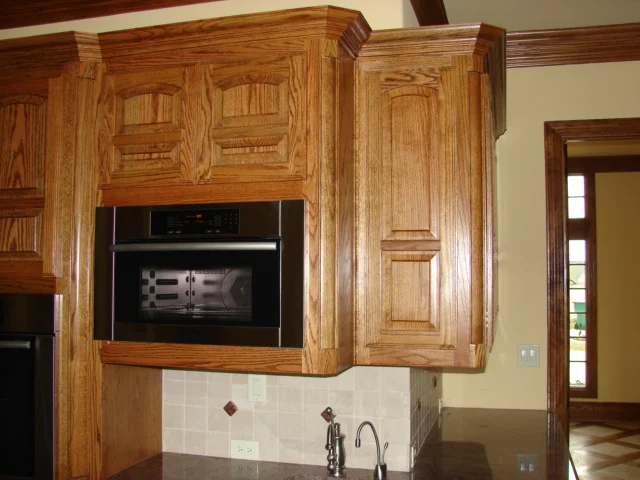  Red oak cabinets with eye brow 1/3 2/3 doors and a standard 1/2" overlay. Classic round corner moulding. 