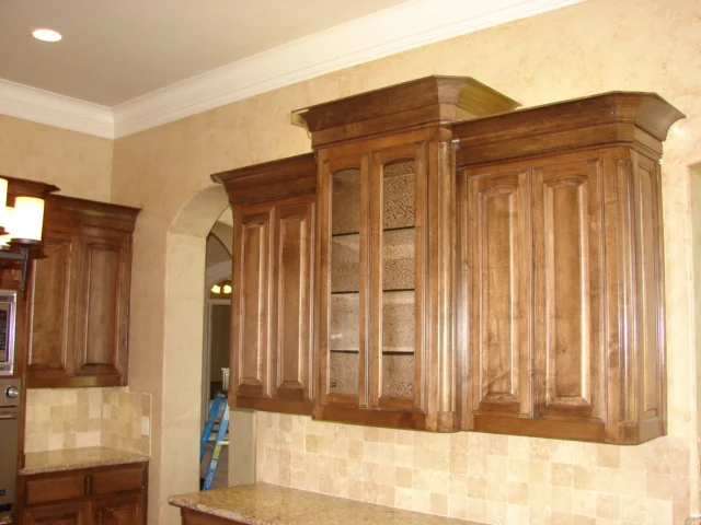  Maple cabinets with raised panel eyebrow arch doors and classic round corner moulding. 