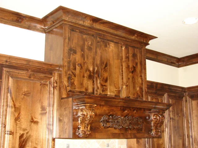  Knotty alder mantel shelf hood cover with corbels and carved applique. 