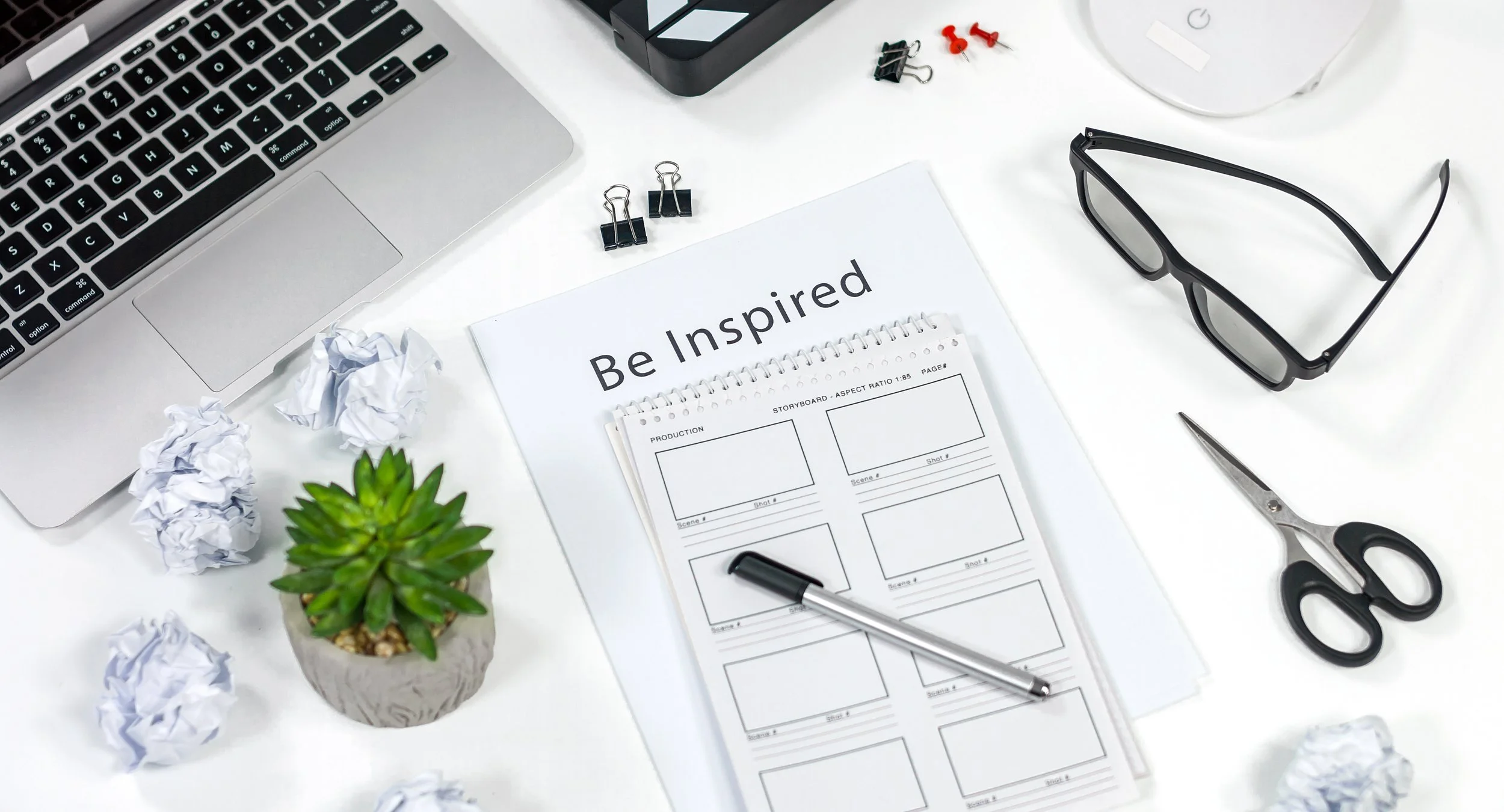 Desktop with laptop pen and notebook