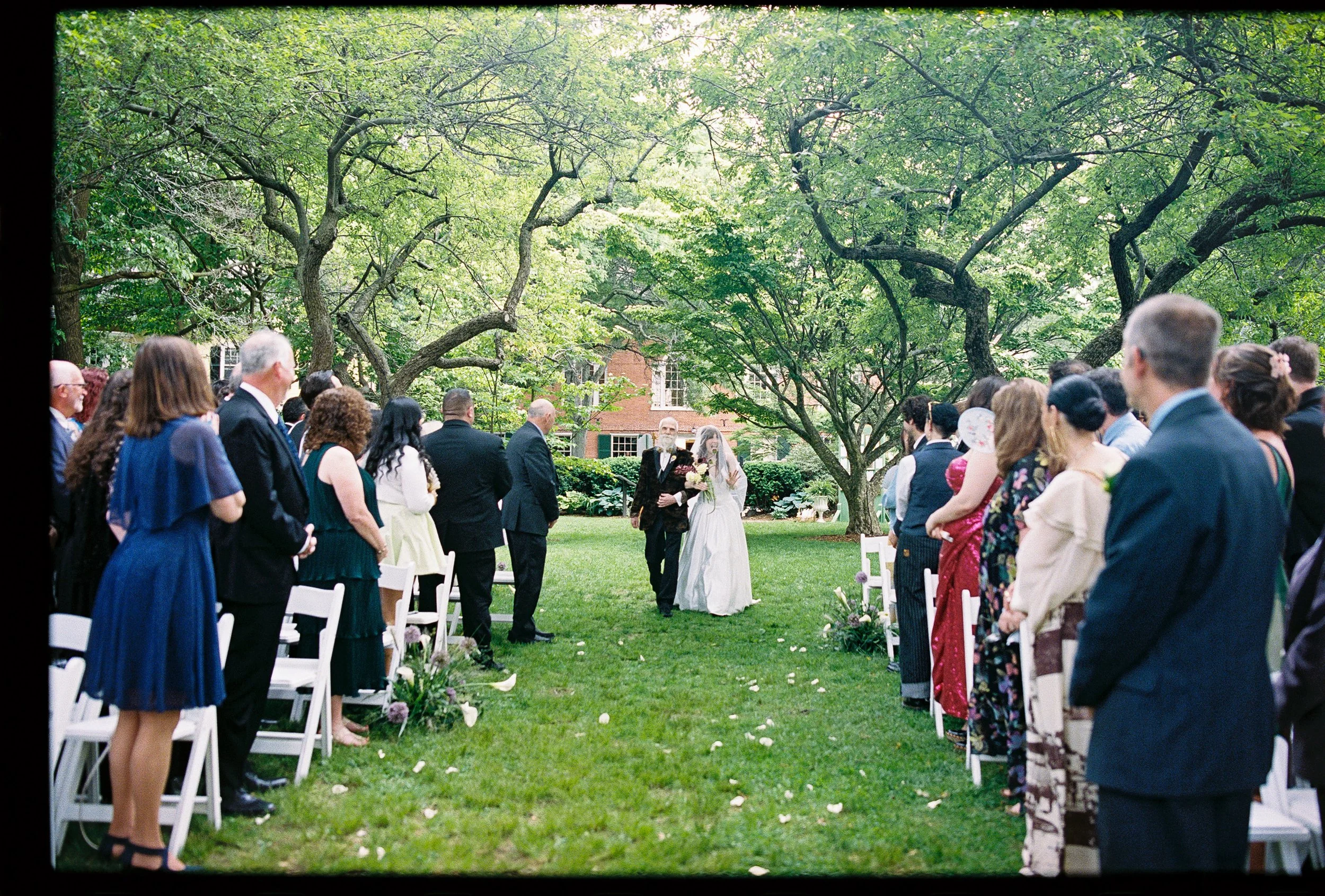A parent walking their child down the aisle during their wedding