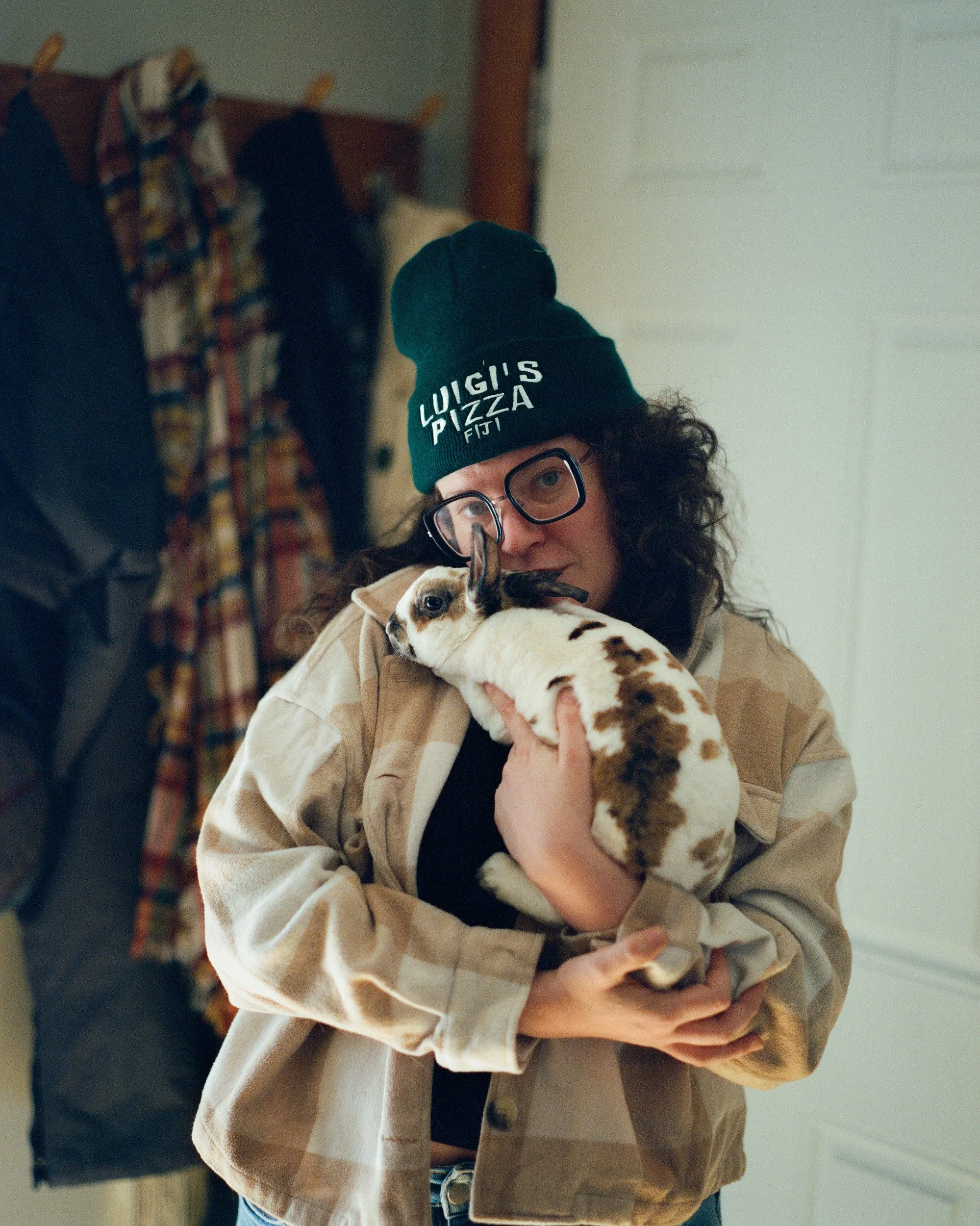 Mel holding a bunny up to her chest