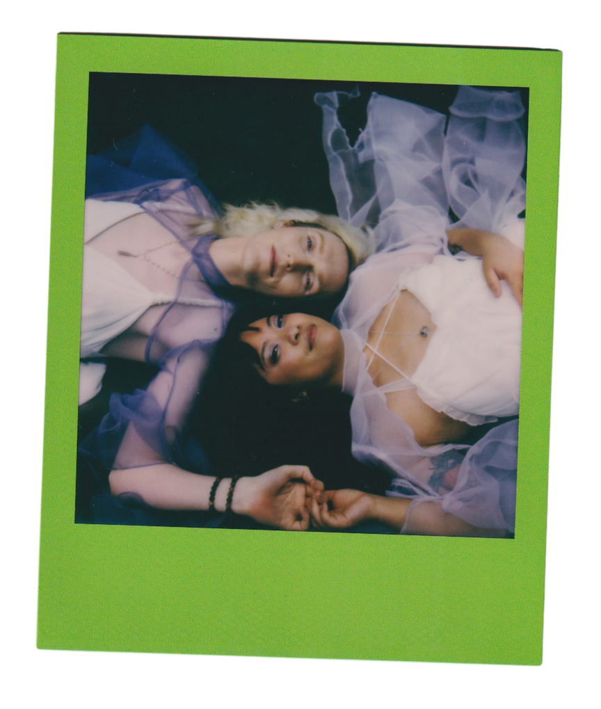Newlyweds laying in opposite directions with their heads laid next to each other