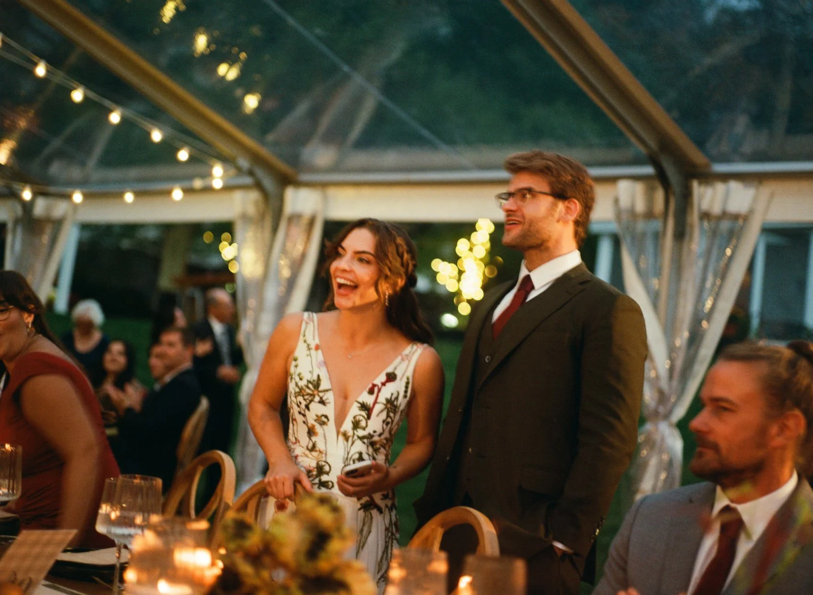 newlyweds laughing during their wedding reception