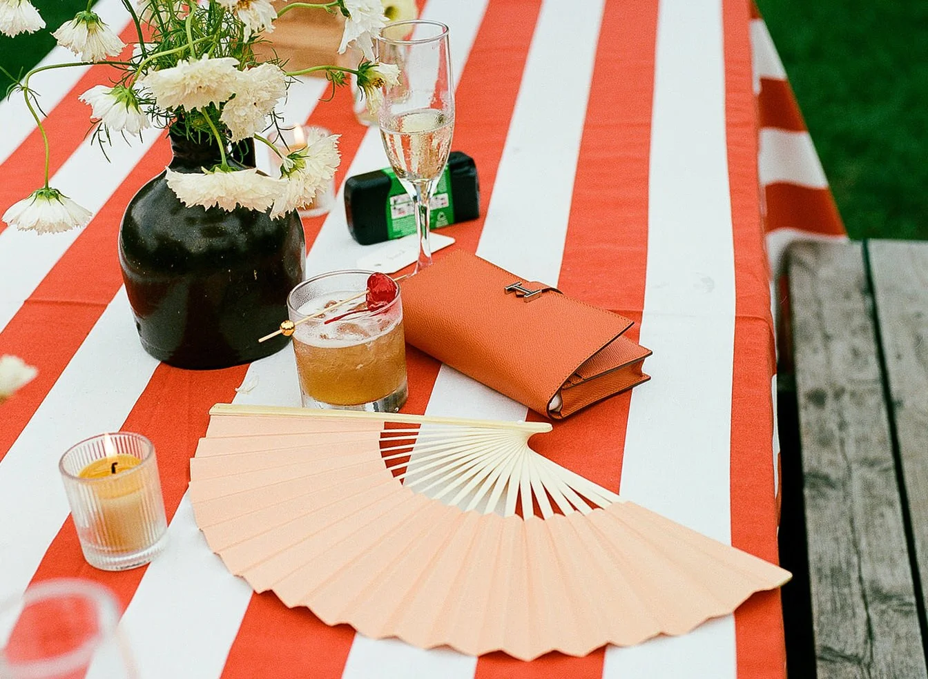 A table with various things laid on it and a red and white table cloth
