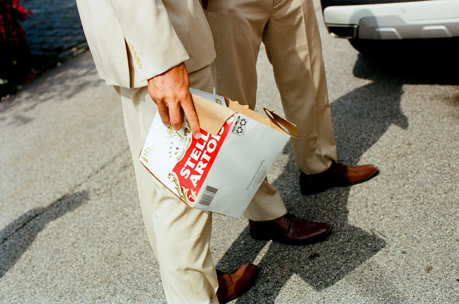 A close up of a person holding a box of beer