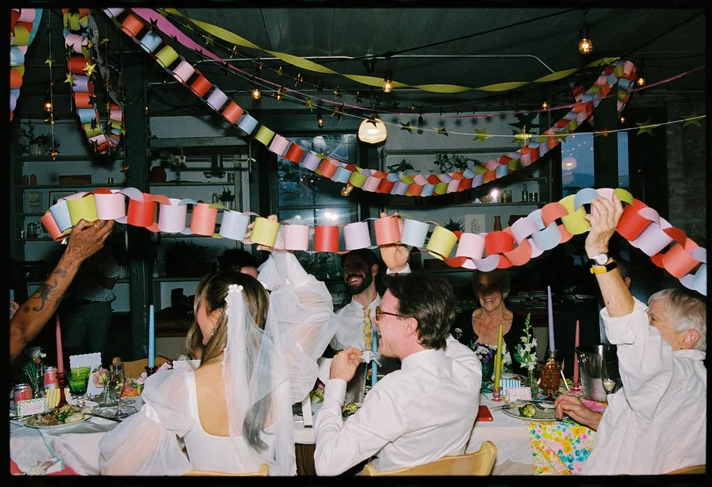 Wedding guests passing around a paper chain during a reception