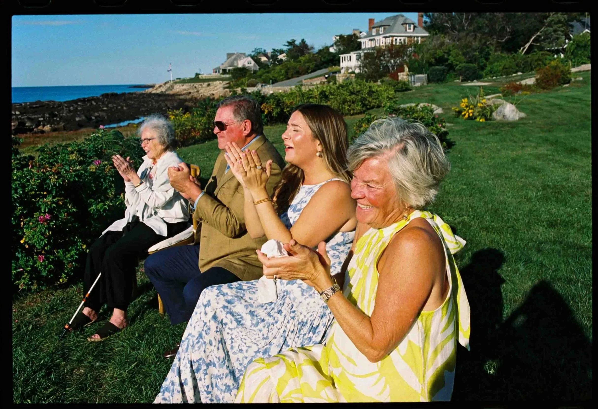Wedding guests clapping as they watch a wedding ceremony