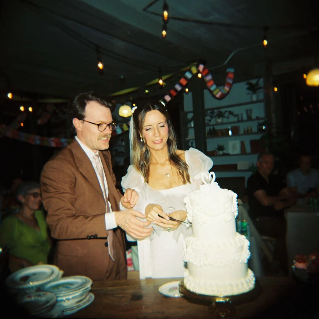 Newlyweds cutting their wedding cake together