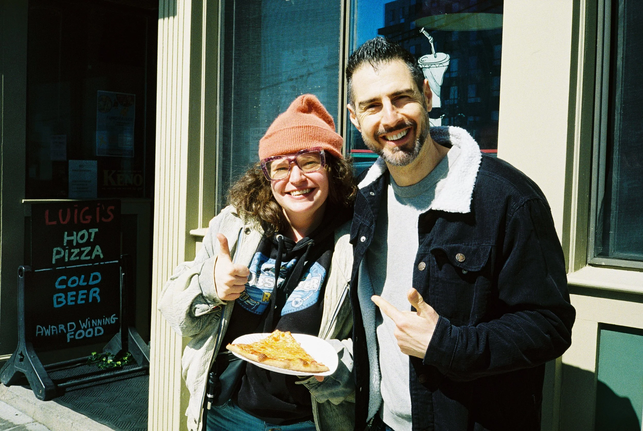 Two people smiling and giving thumbs up