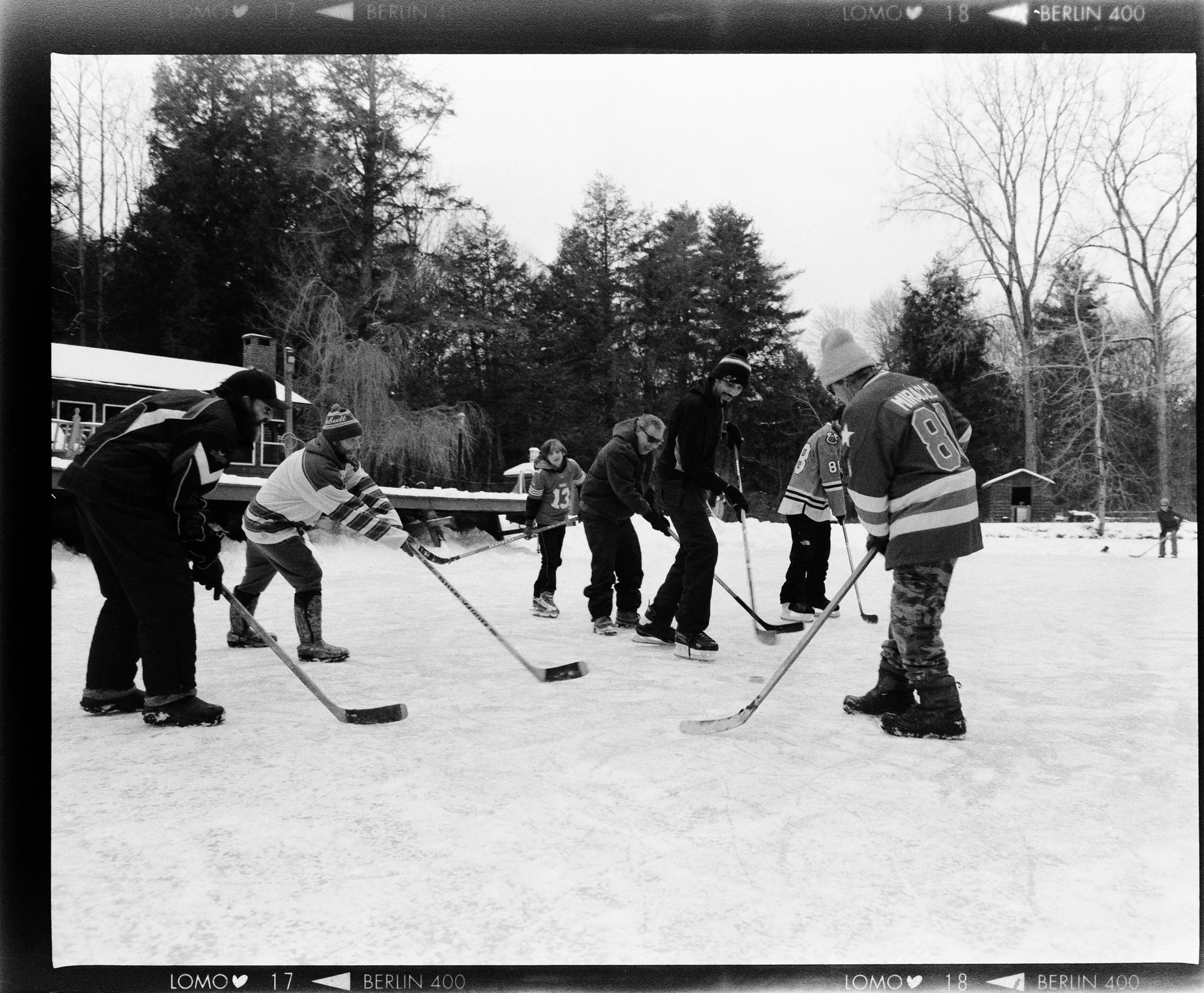 A group of people playing ice hockey on a home rink