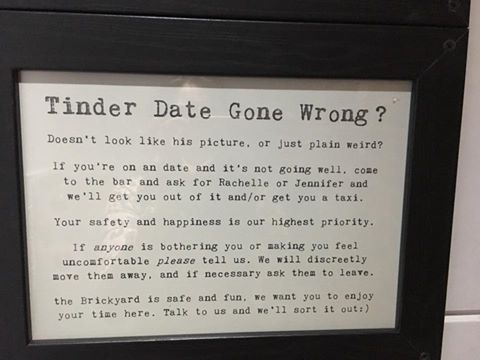 A bar in England has a sign offering to help women on bad Tinder dates