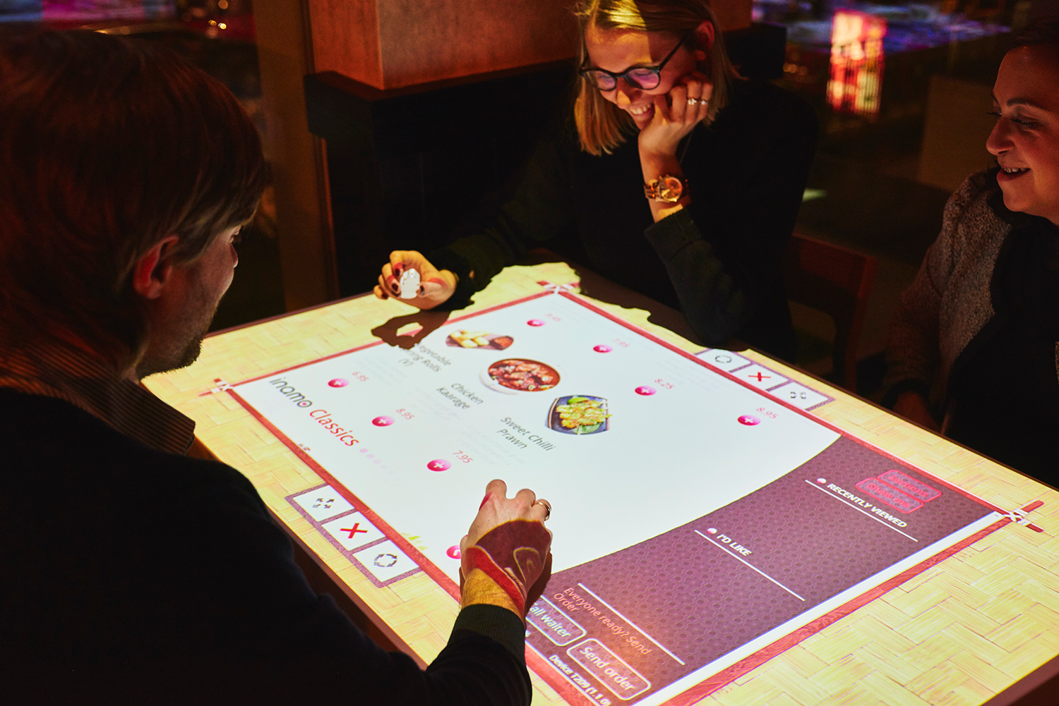  Guests can order food through their interactive menu projected onto their table. 