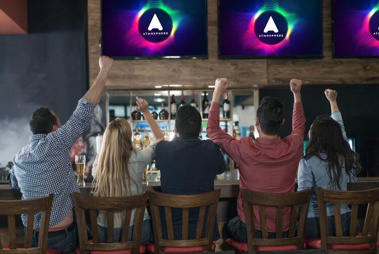 The Four Types of Digital Signage for Bars & Restaurants Group of young restaurant patrons watch Atmosphere TV at a bar top.