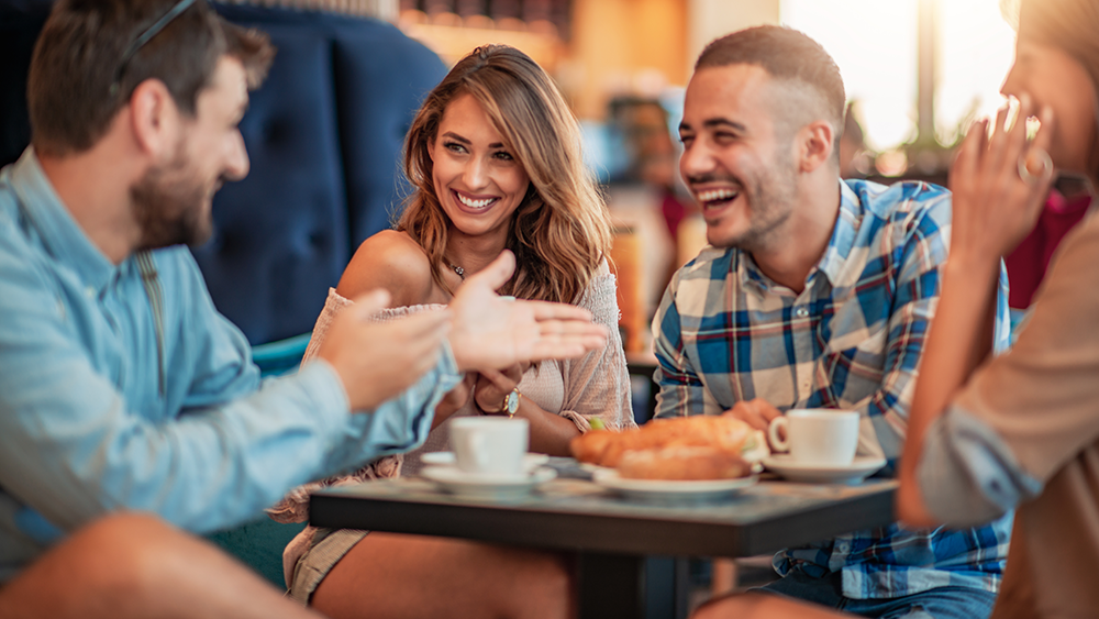 Group of friends having fun at a restaurant and cafe