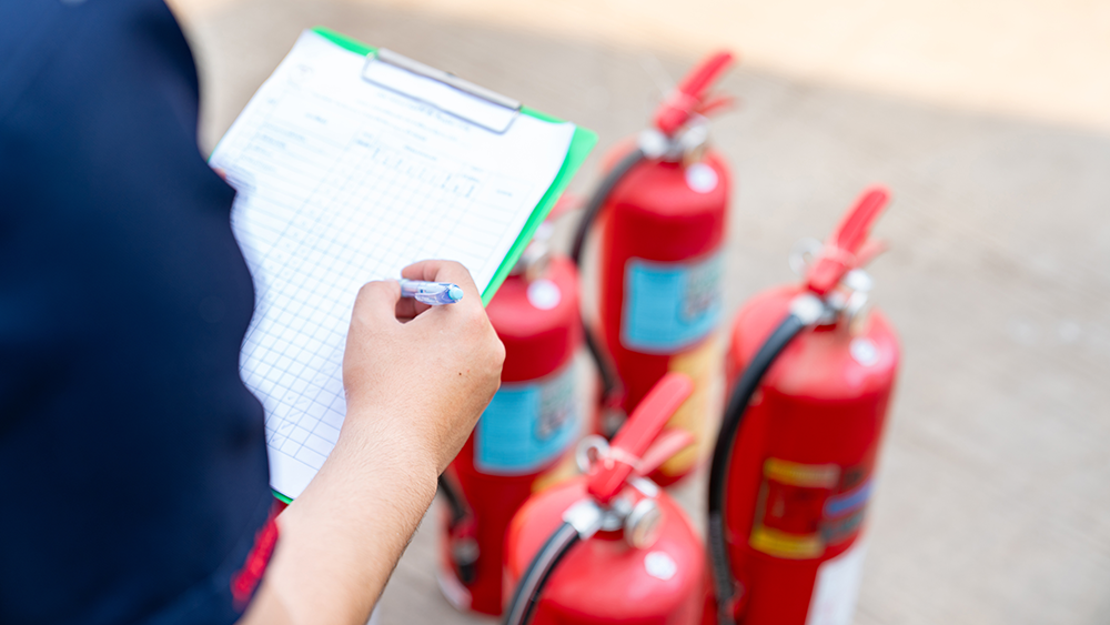 Fire marshal checking out a restaurant's fire extinguishers