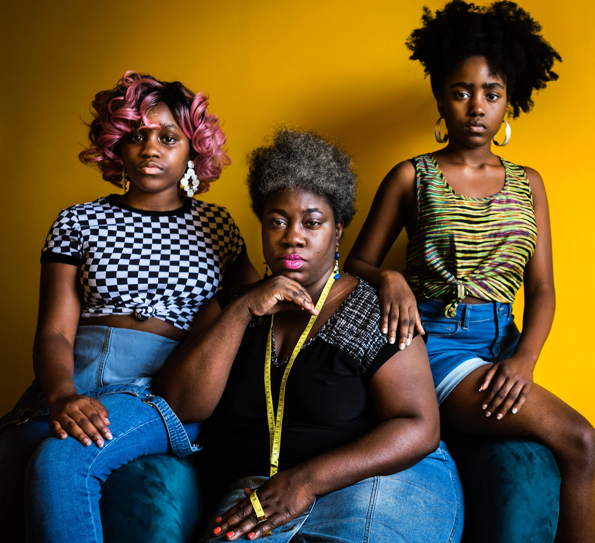  Angel Fant sits for a portrait with her daughters, Danielle Fant (left), 19, and Tenijah Fant (right), 18, on Friday, July 19, 2019, at Fearless Winston-Salem in Winston-Salem, N.C. Fant and her two daughters have a fashion line, No Punching Bags, t
