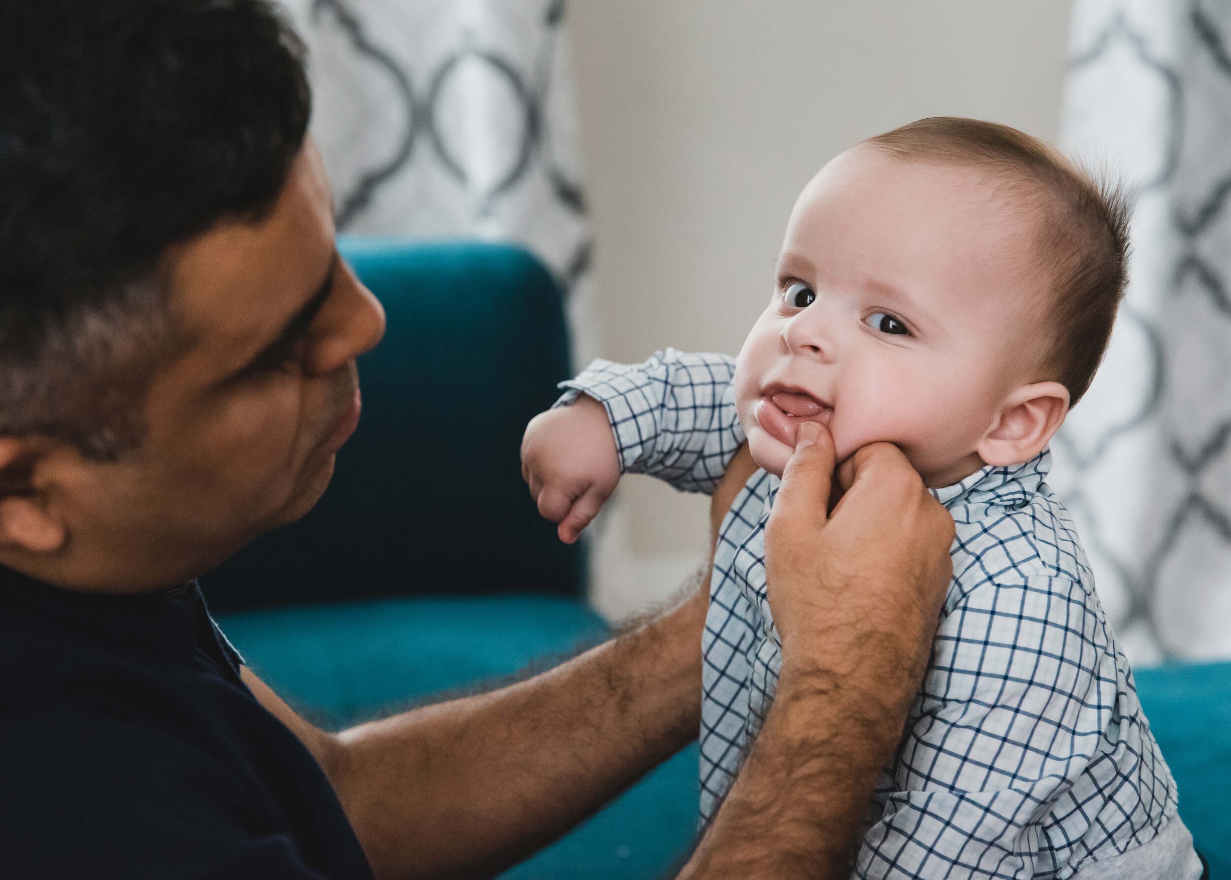 Dad cleaning baby's face at home