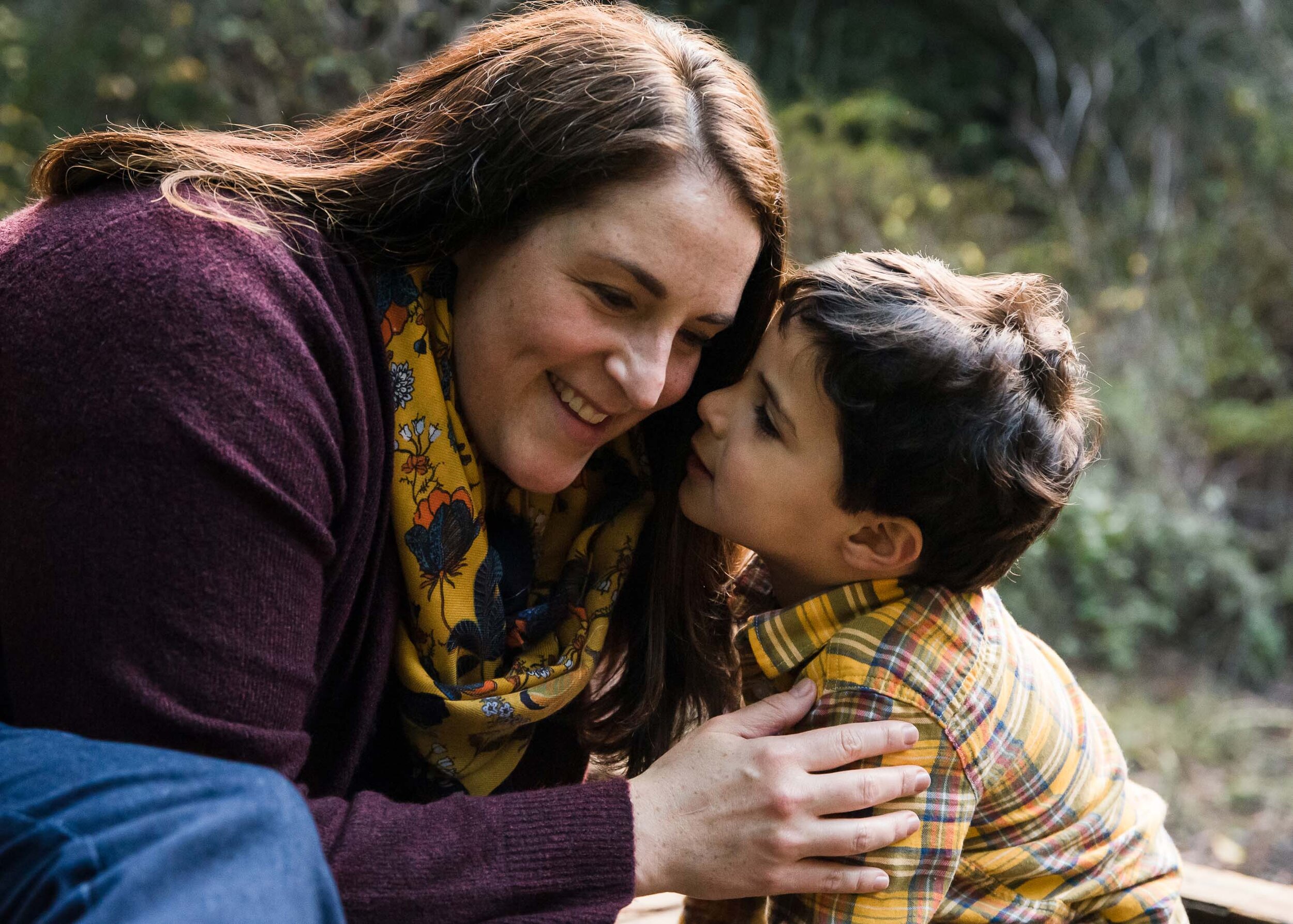 Mom and preschool son whispering