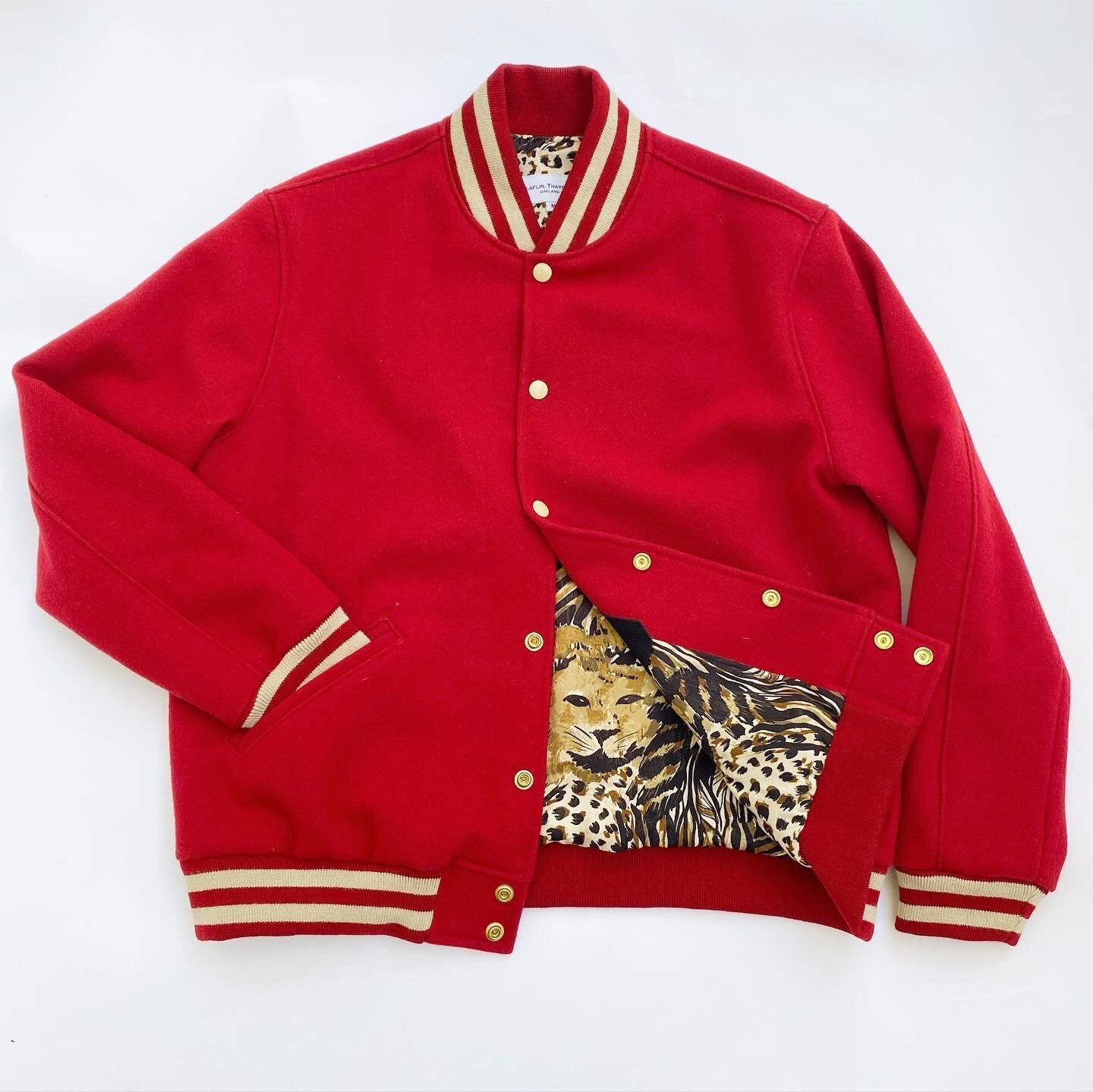  Red wool, cream stripe details, animal print lining 