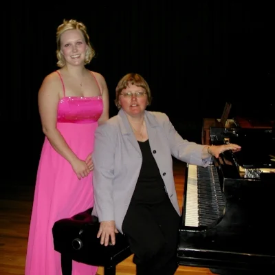 Cousins in recital: seated Laura (Oinonen) Yrjanson after accompanying her daughter, Sarah Yrjanson (now MacDonald), playing a movement of the Mendelssohn Violin concerto