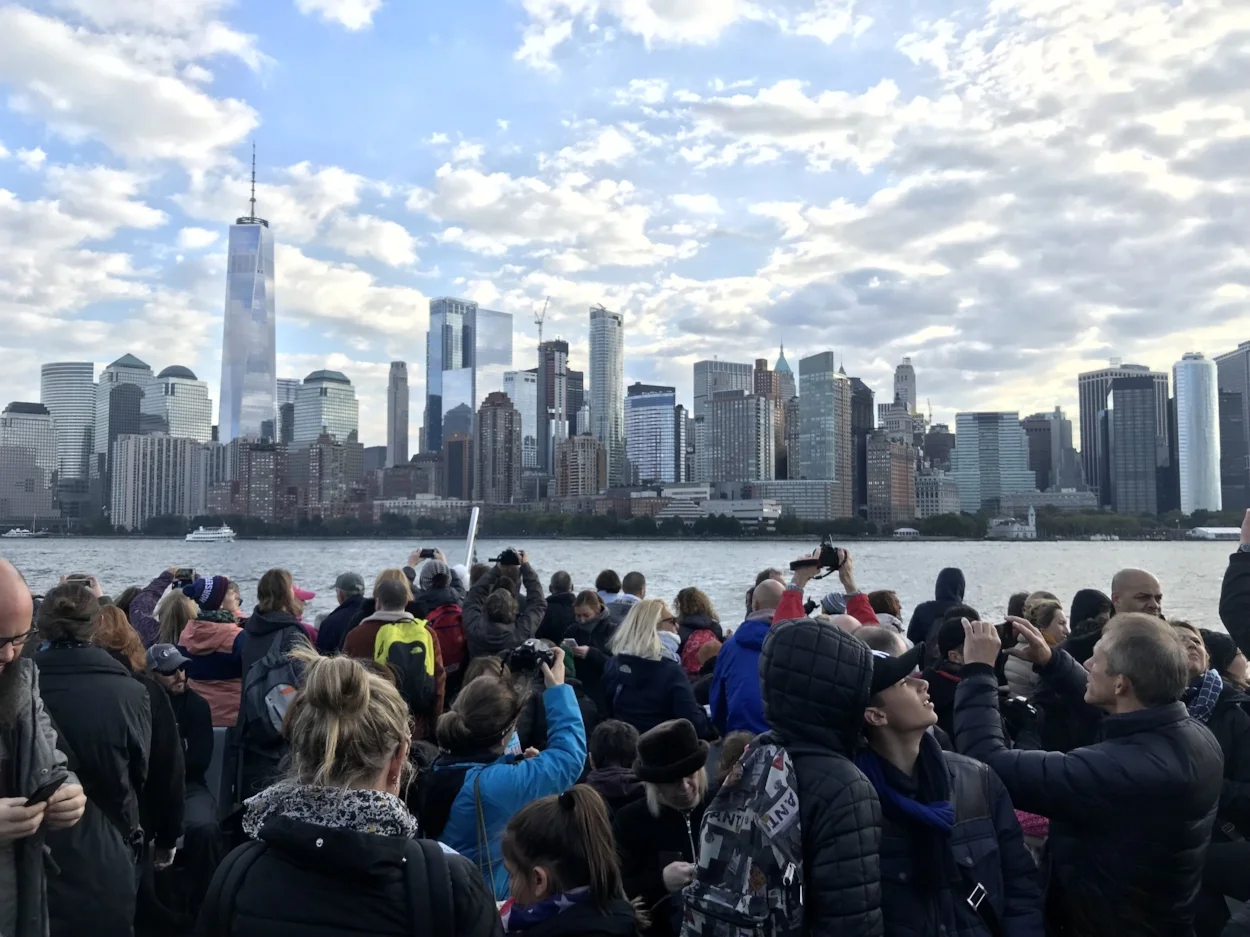 Huddled masses yearning for a good picture of Manhattan, as the boat leaves