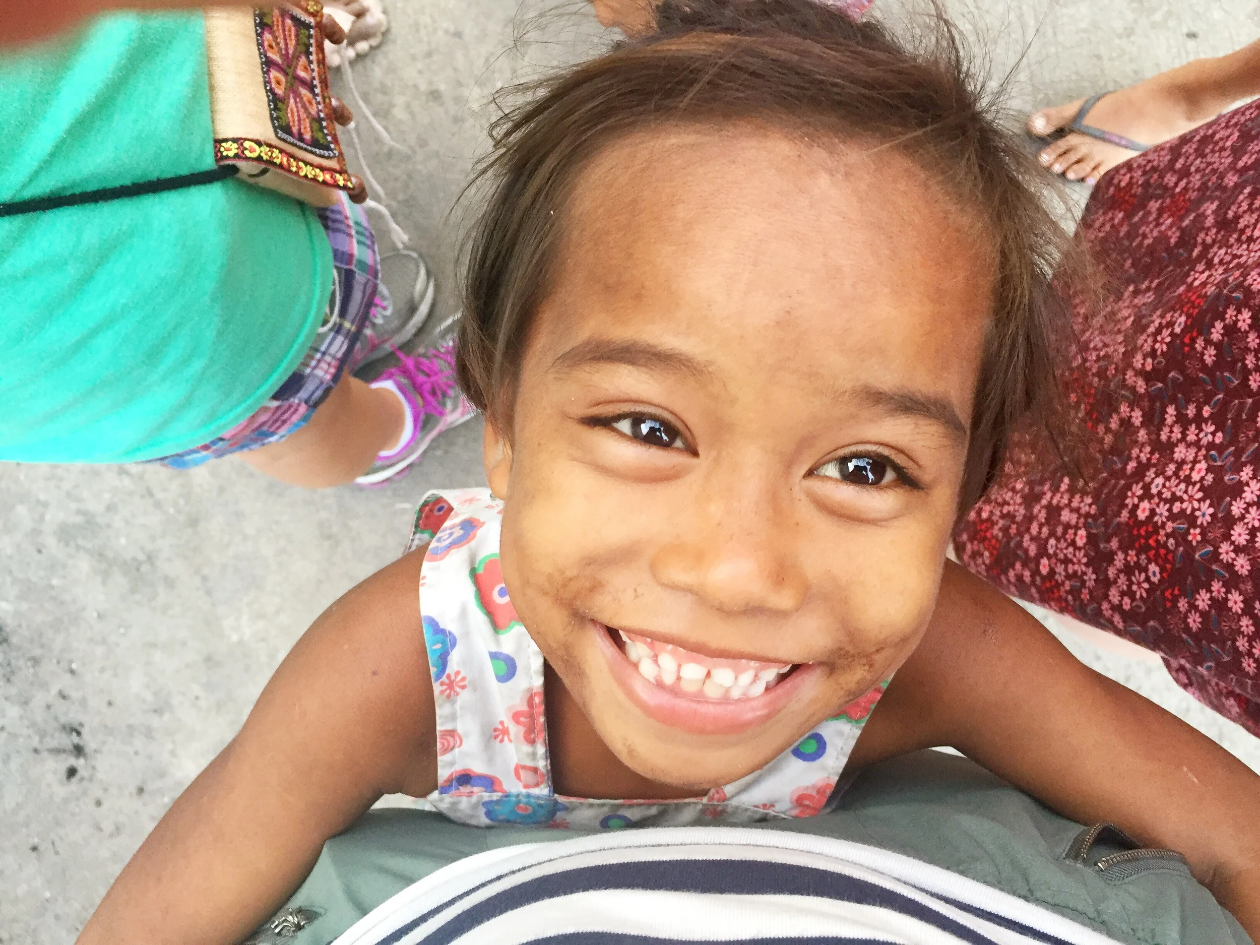 This kid has essentially nothing, but she's so happy!