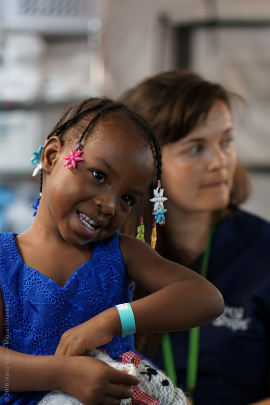 Faith before her surgery. Her sister could be her twin, they look so much alike and have the same hair beads. 