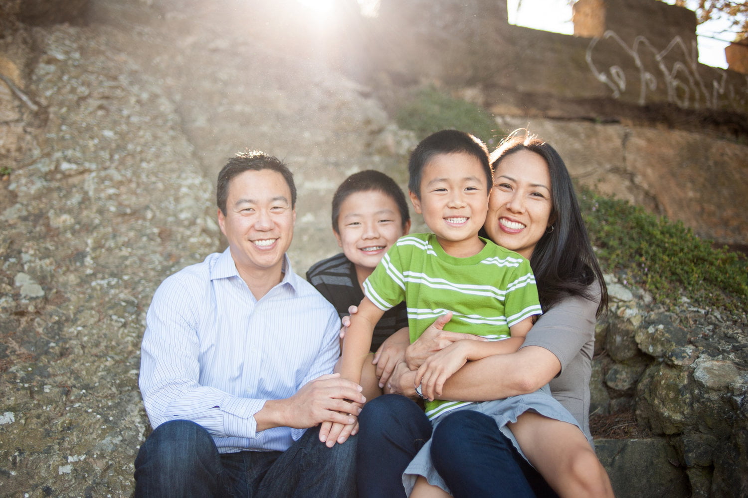 Happy family sitting in sunlight