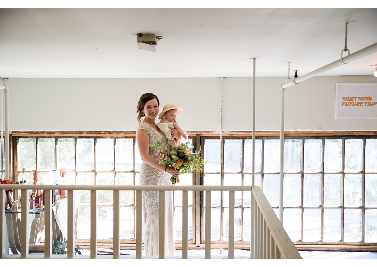 Bride holding daughter before wedding ceremony