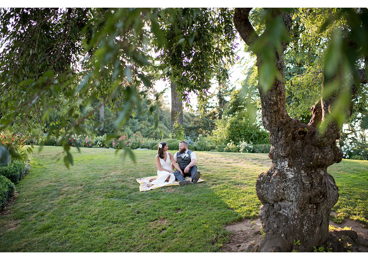 Bride and Groom sitting on lawn at Pittock Mansion 