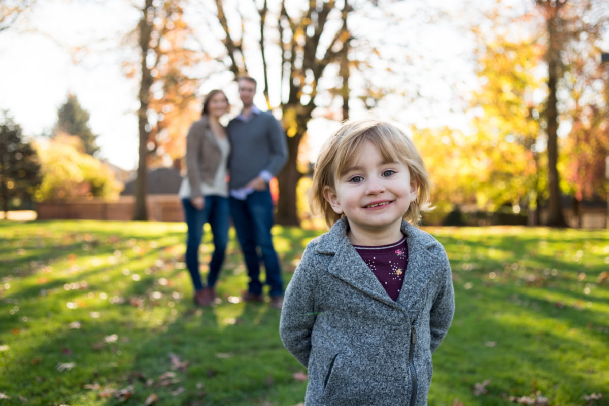 Photo of girl in front of parents at Berkeley Park in Portland