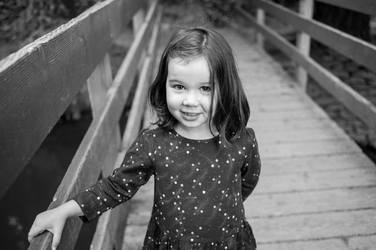 Photo of girl on wooden bridge at Crystal Springs Rhododendron Garden