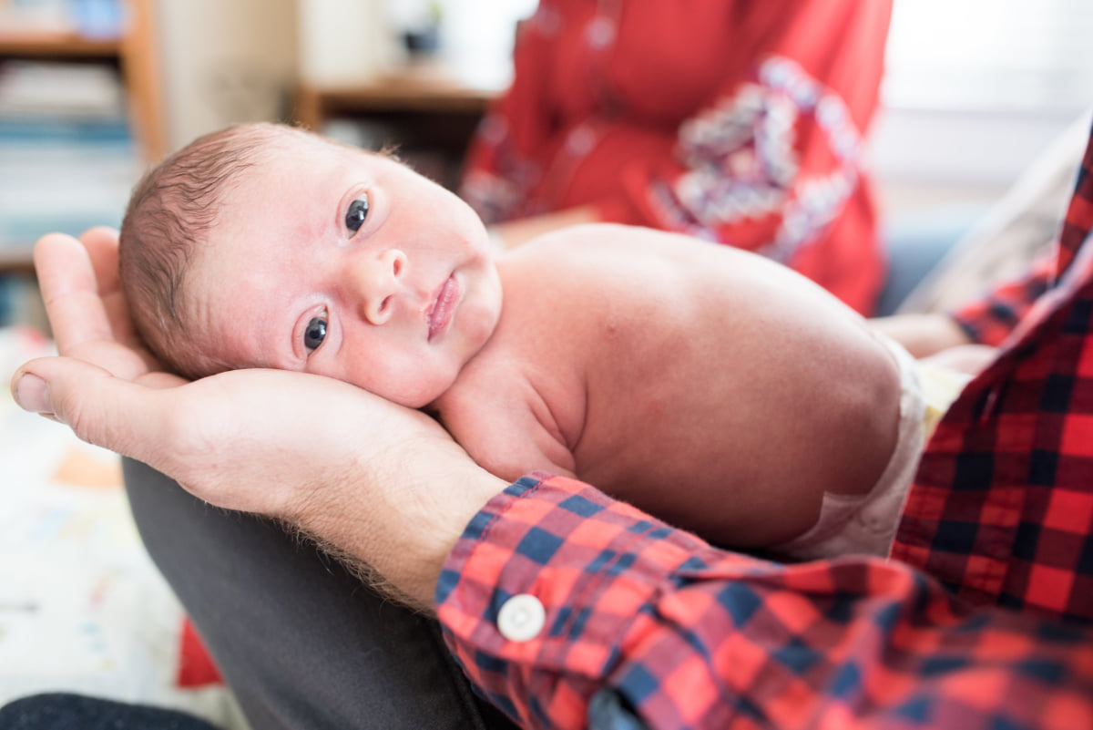 Photo of newborn baby looking into camera