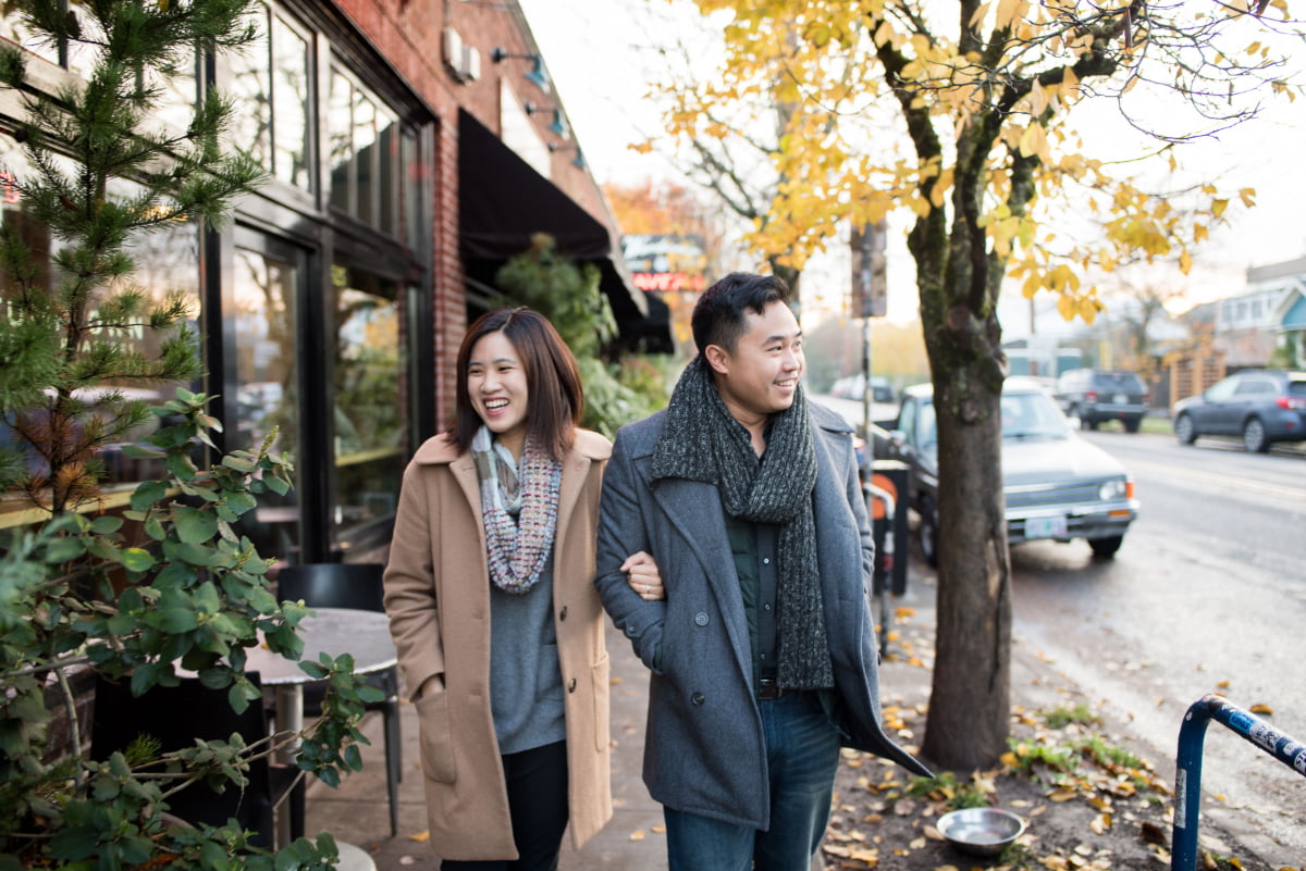 Candid photo of couple walking on Division St. in Portland