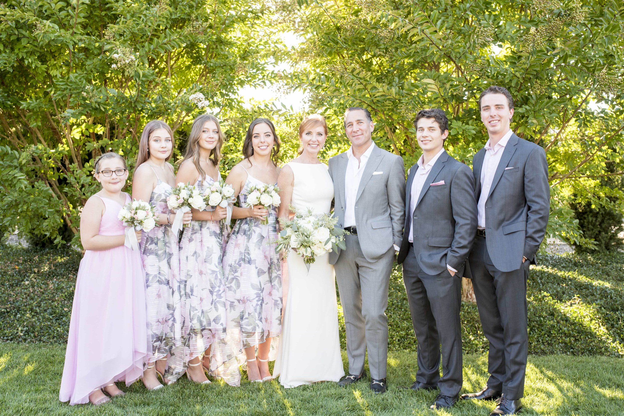 Family portrait of bride and groom with adult children