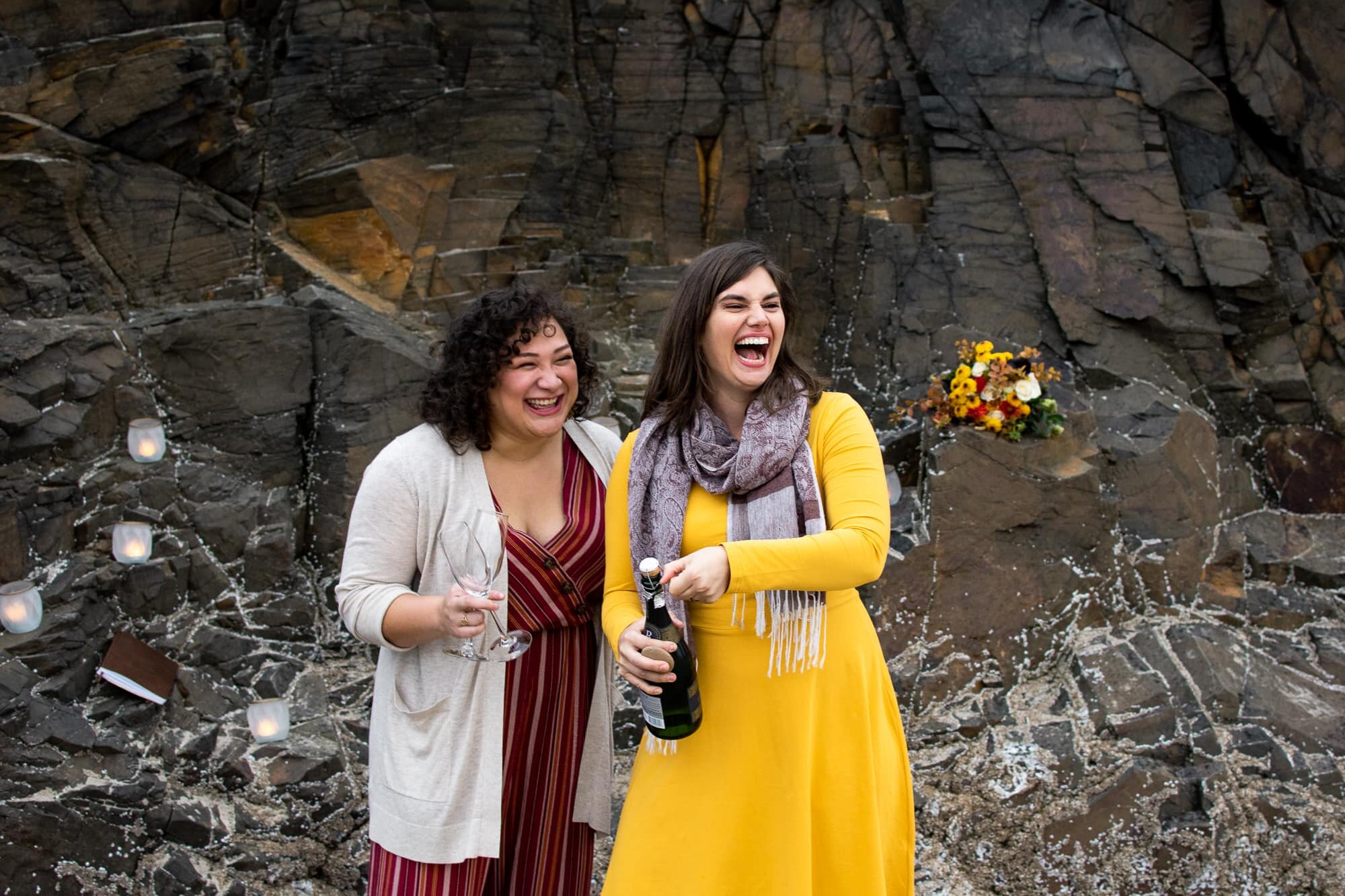 Couple popping champagne after marriage proposal on Oregon Coast