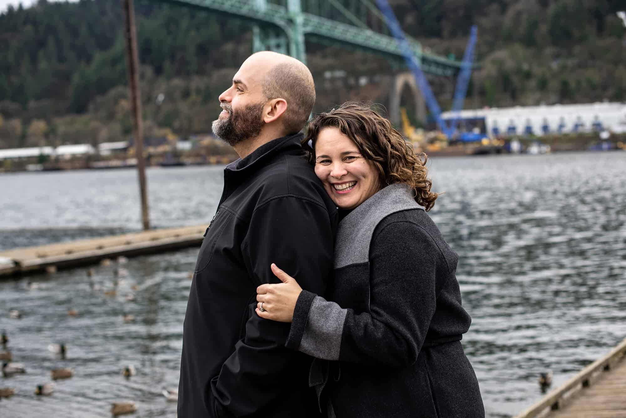 Happy couple on boat dock at Cathedral Park