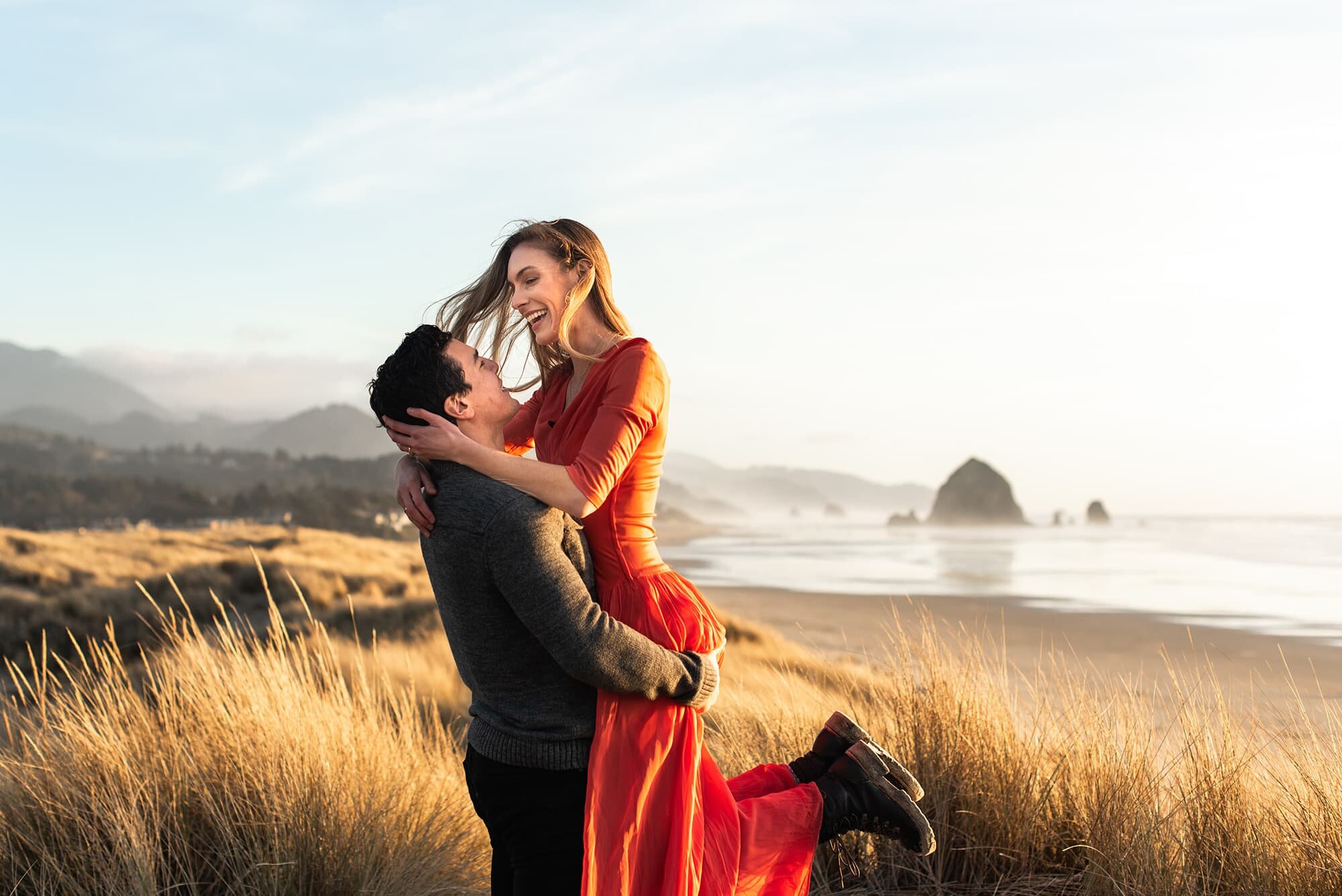 Woman jumping into Man's arms at Cannon Beach