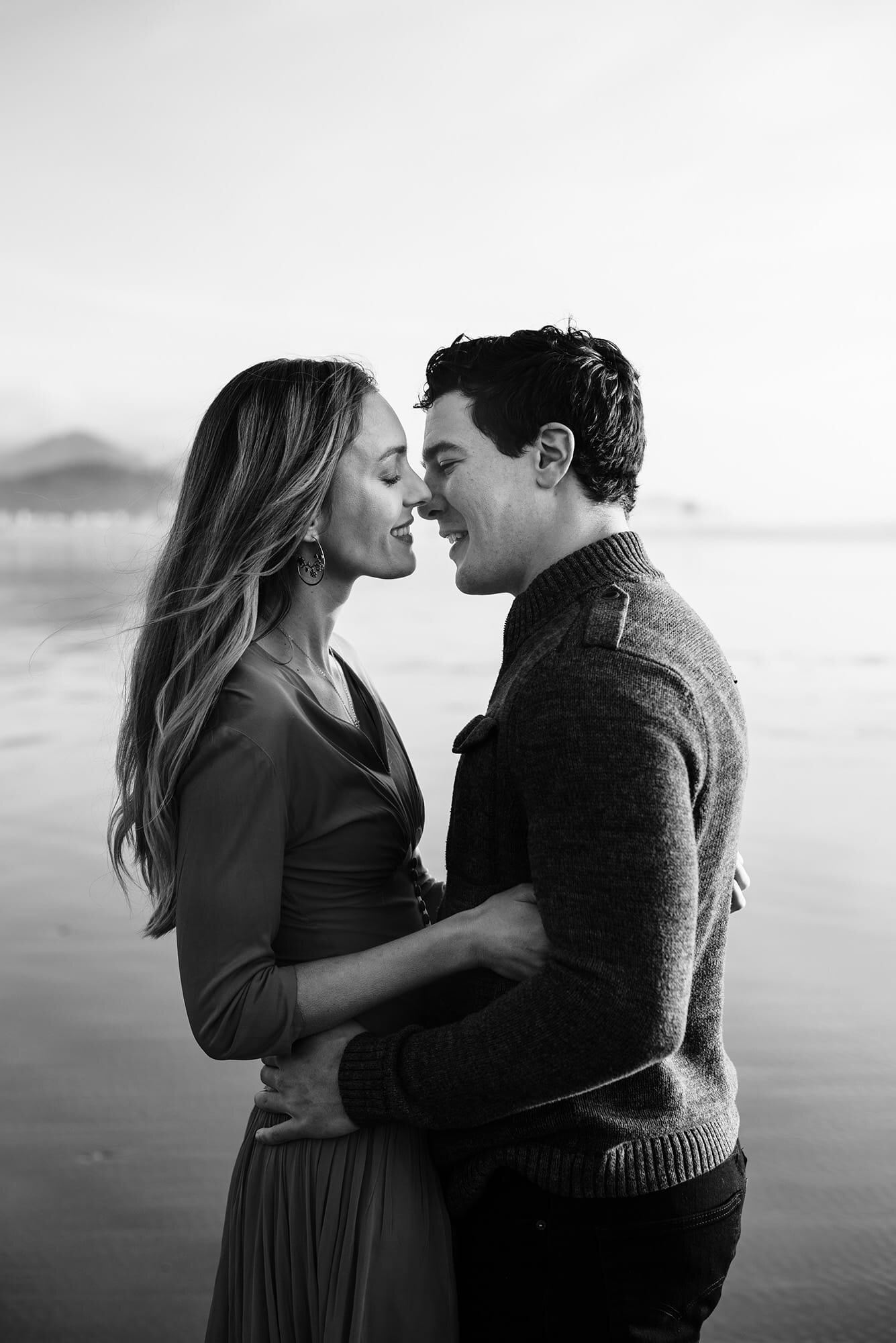 Black and White of Couple on Cannon Beach Kissing