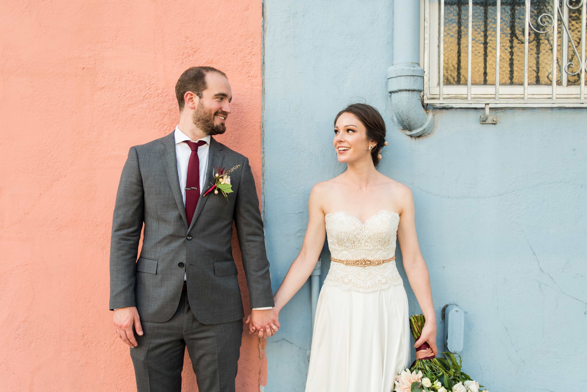 Bride and Groom in front of colorful urban Portland pink and blue wall