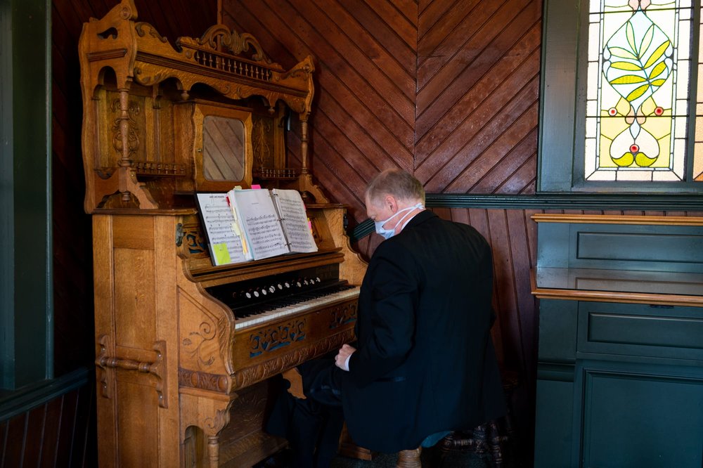 Organ player sitting at Organ in Oaks Pioneer Church